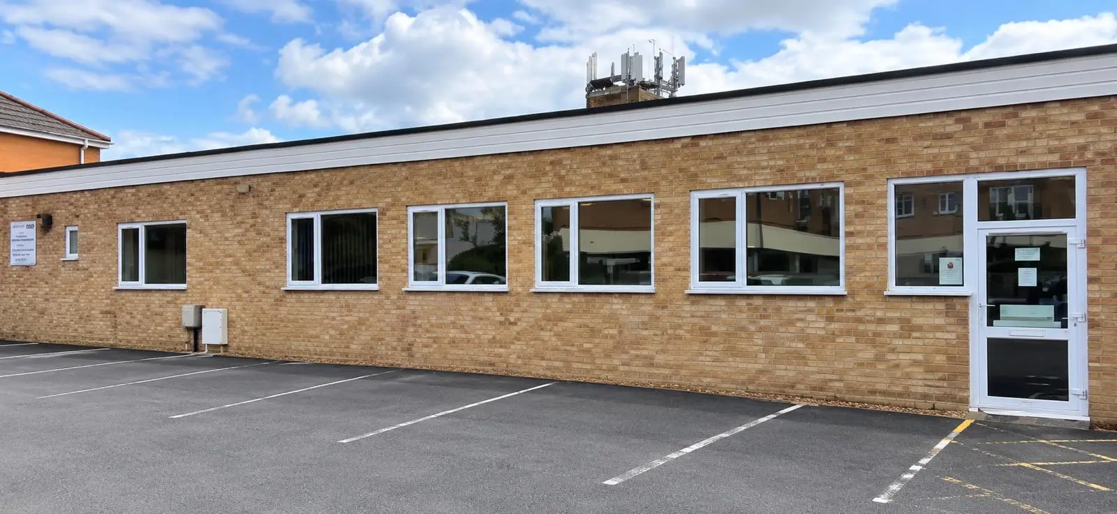 The Silver Band Hall, Kidlington: a long single-storey brick hall with white-framed windows and its own car park